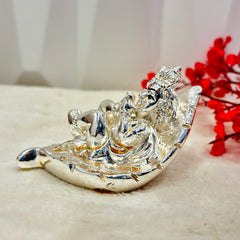 Bring a touch of whimsy to your home with our Silver Baby Krishna figurine, nestled in a delicate leaf. Standing at 5.7 inches, this playful piece adds a playful and charming touch to any room. Perfect for lovers of unique and quirky Decor.
